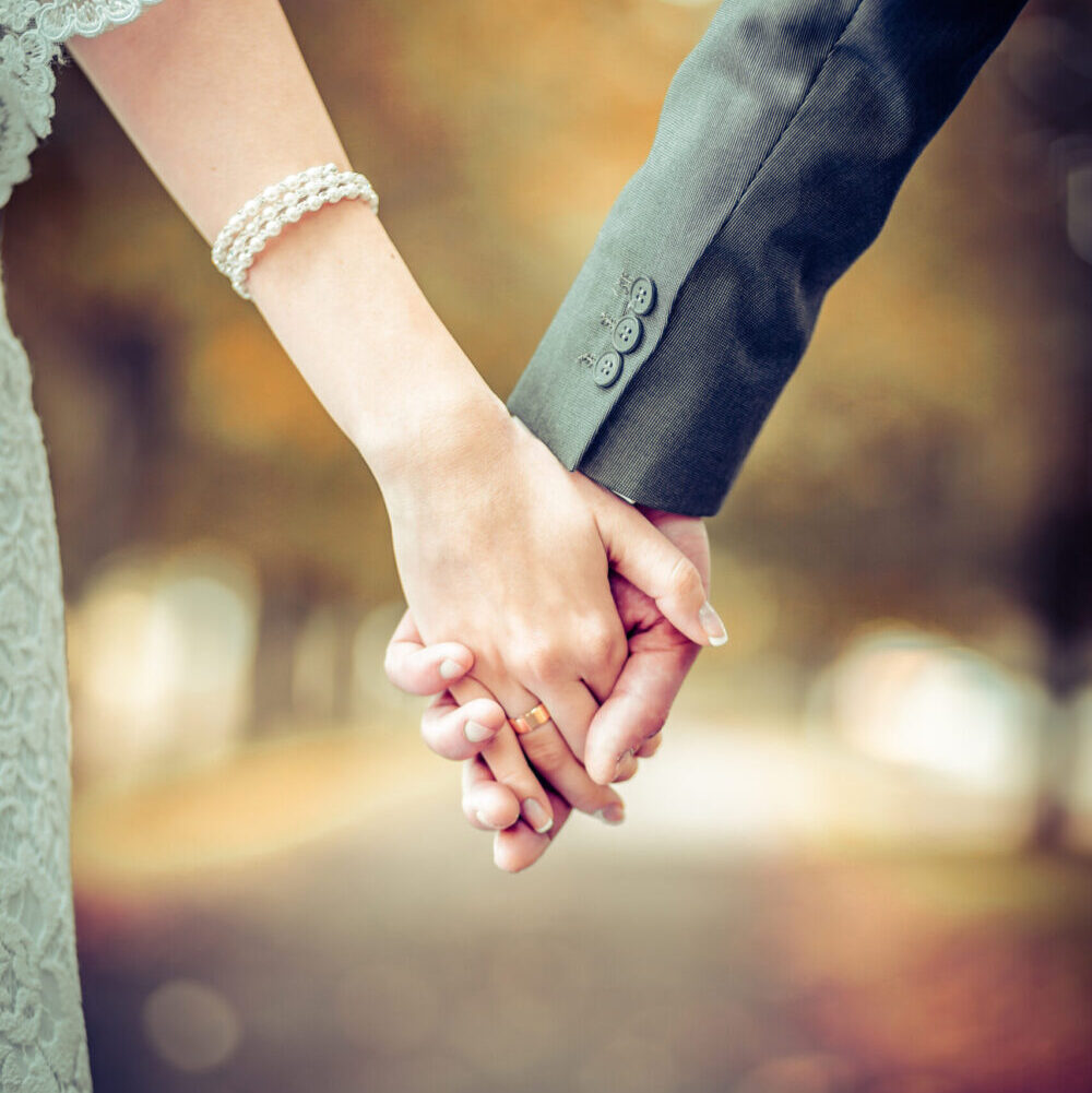 bride and groom holding hands