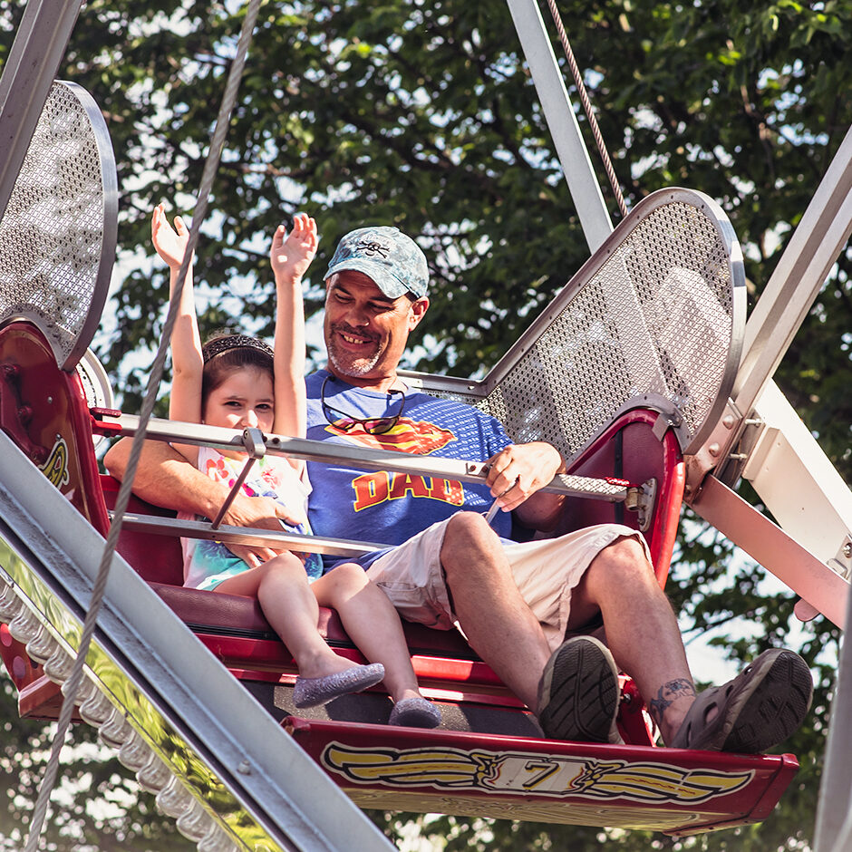 a father and daughter riding the Big Eli Ferris Wheel